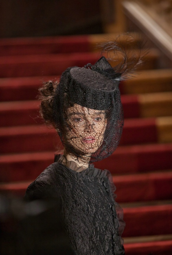 Upon fleeing home Anna dons an asymmetrical black crushed silk gown with a hat and veil that essentially hides Anna’s face. 